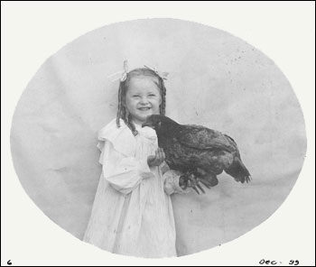 Miriam holding a chicken, Fort Lawton, December 1899